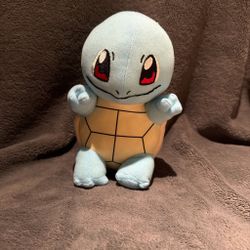 Pokémon squirtle plush with orange shell and black hexagonal lines