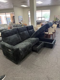 Power reclining sofa with storage chaise