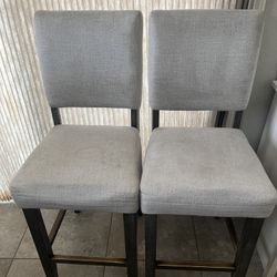 2 Bar Stools  Wood  Chairs . The Wood Is Dark Gray and Cushions Light Gray