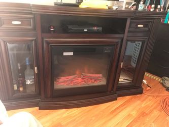 Media console with electric fireplace.