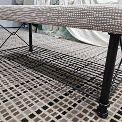 Sturdy Indoor/ Outdoor Bench With Black Iron Base And Tan And Cream Color Fabric.