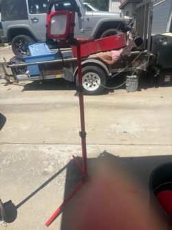 Craftsman portable LED work light mounted on an adjustable telescoping tripod stand with detachable base handles.