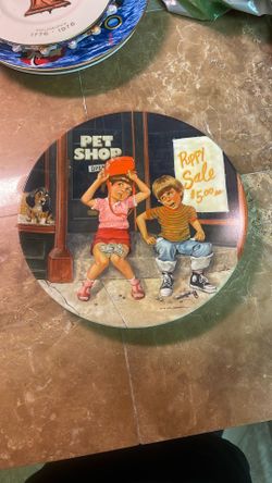 This item is a 1982 vintage collector plate titled "The Pet Shop," featuring artwork by Mike Hagel. It is part of "The Children's Hour" series produce