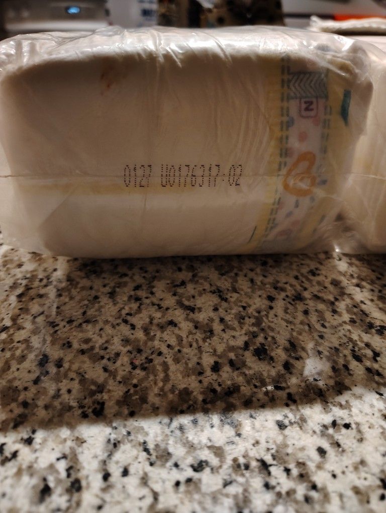 Two Packages Of Diapers For Newborns