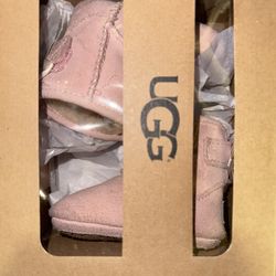 Never Worn UGG Jesse Bow II booties in the color baby pink suede with a satin ribbon. Size 0/1
