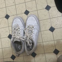 white Nike Court Borough Low 2 sneakers. 