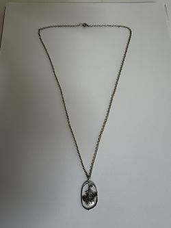 Sterling silver necklace with a multi-masted sailing ship pendant inside an open oval wire frame