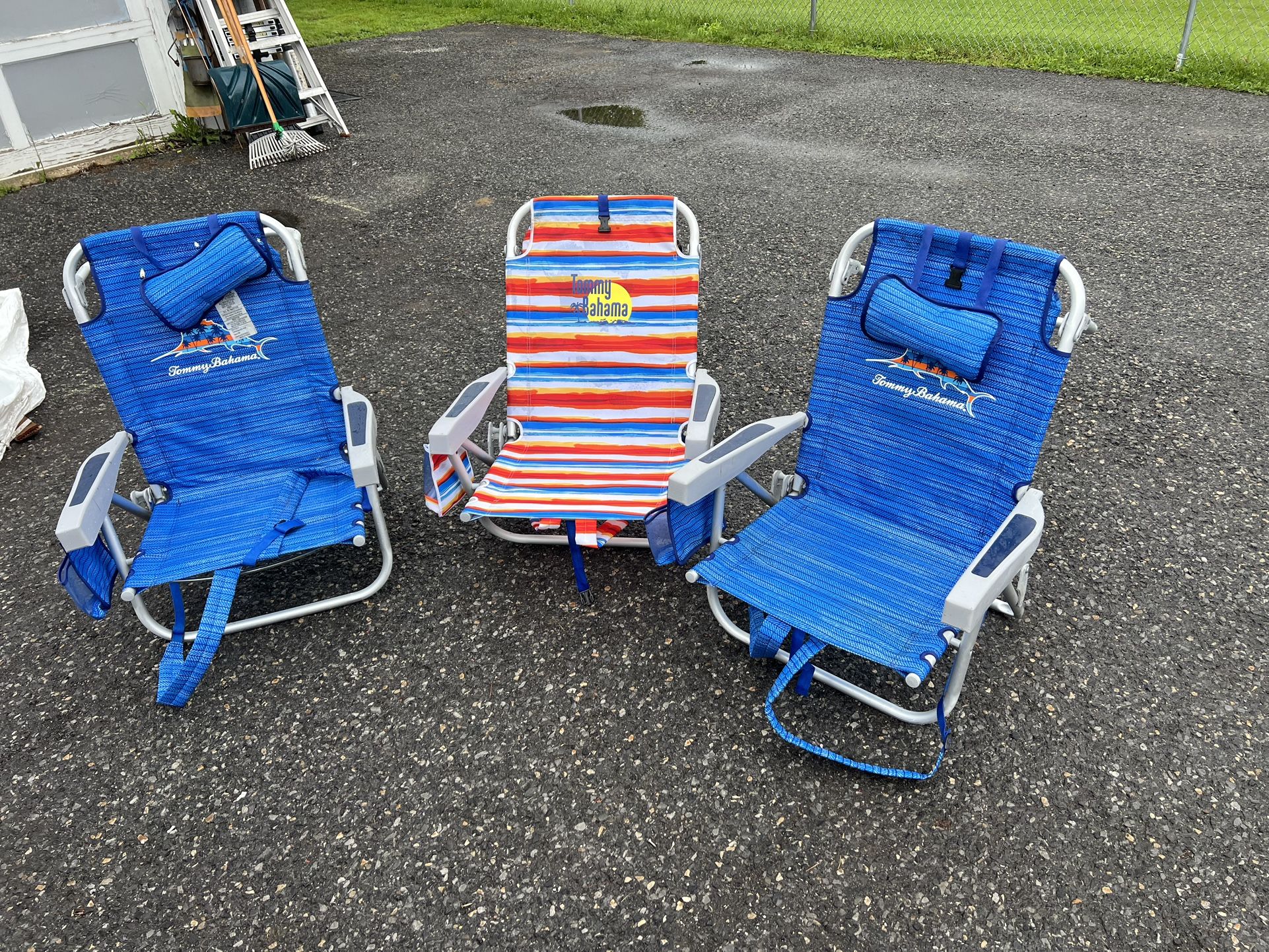 Three Tommy Bahama beach chairs was coolers on the back and straps for caring two events