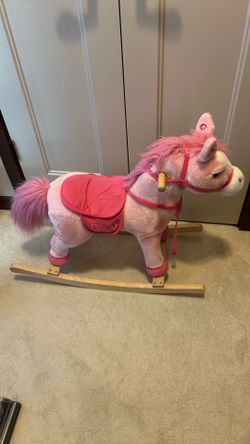 Pink rocking horse toy with sounds.