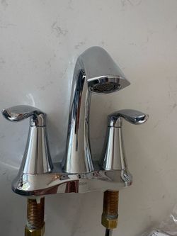 White pedestal sink with MOEN faucet