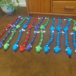 Collection of brightly colored plush snakes
23 Pieces