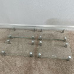 4 x Glass Monitor Stands with height adjustable ~ 15”L x 10”W X 3”H per stand   Price listed includes for all four stands  