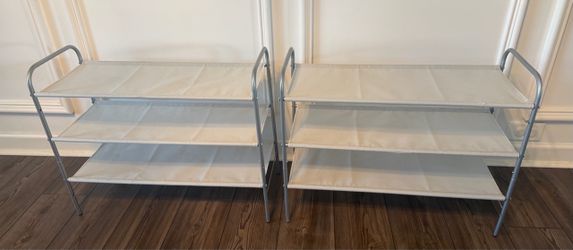 Two grey shoe racks
