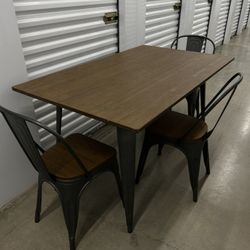 metal and wood table with three chairs