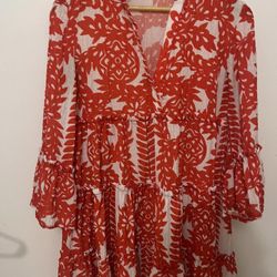 Red and white floral print dress with ruffled sleeves and tiered skirt