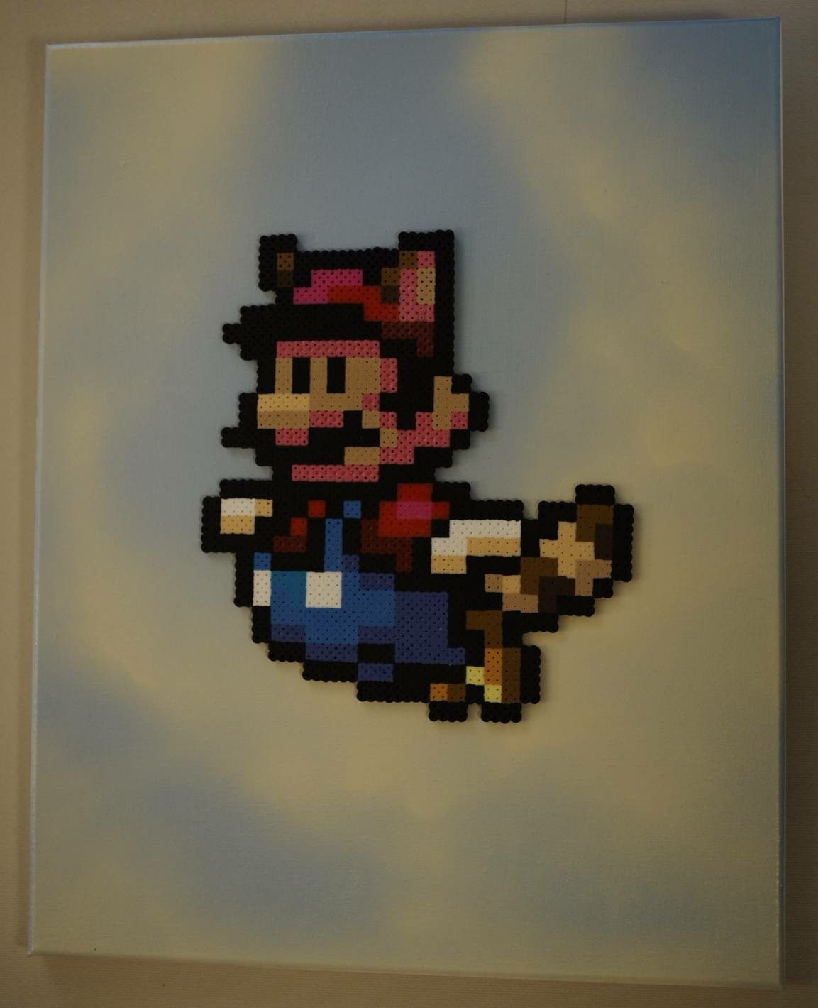 Super Nintendo Perler Bead art on canvas flying raccoon Mario