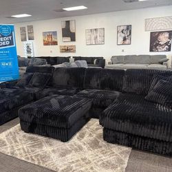 Black jumbo corduroy modular living room sectional sofa with ottoman