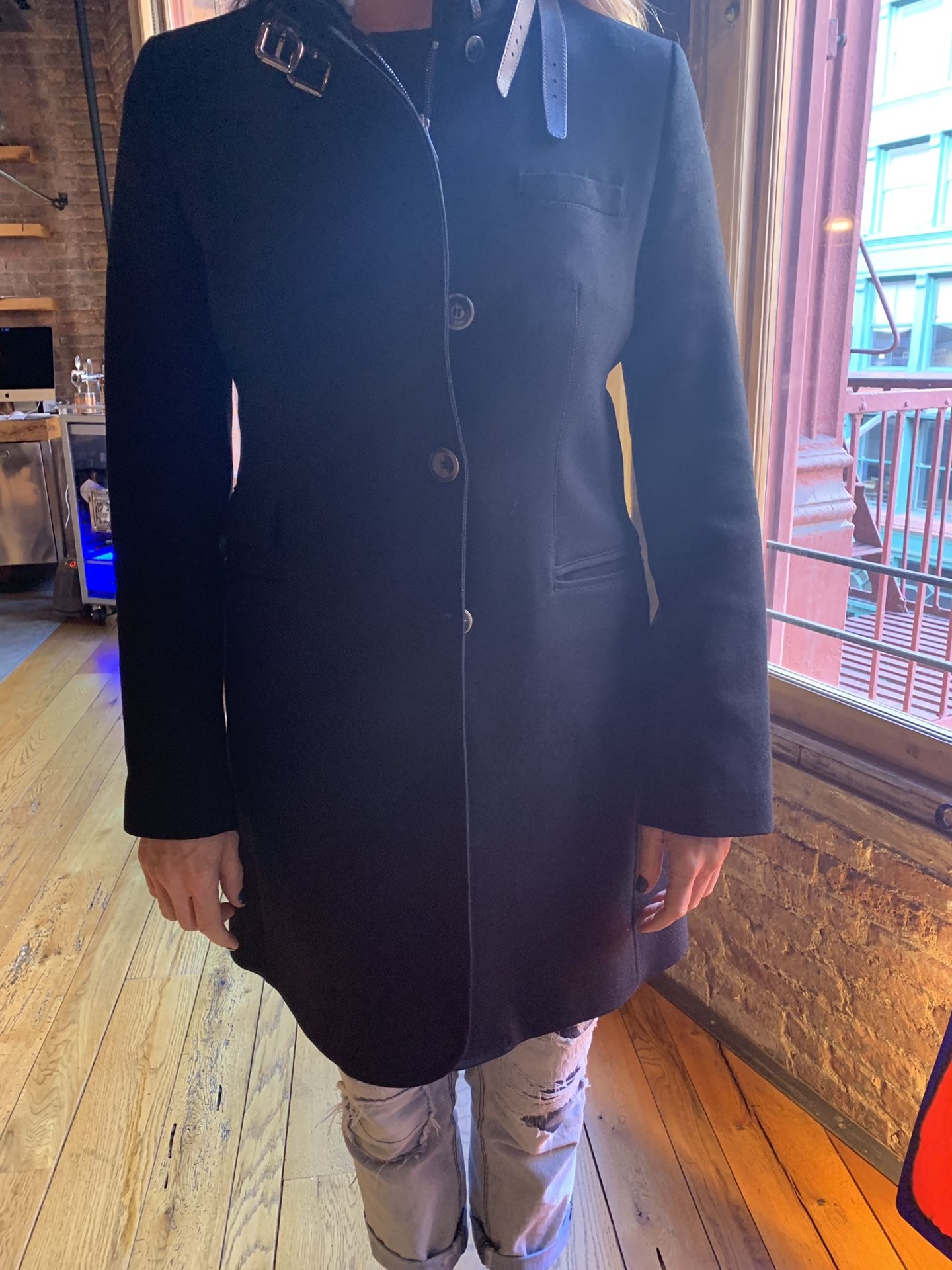 Black wool coat with shearling collar and leather straps