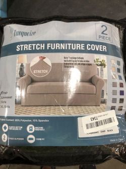 Black,  textured stretch slipcover featuring a subtle jacquard grid pattern designed to fit a standard loveseat.