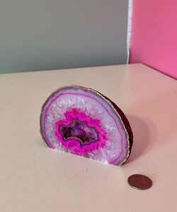 Polished pink agate geode slice with quartz crystal center