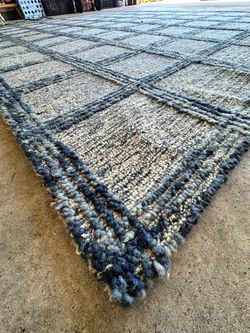 The Nourison Home Ayla Area Rug in Denim (Model AYL01) is 100% hand-made wool rug featuring a distinct