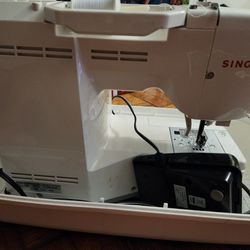 Sewing Machine With a Case and A Thread Attached 