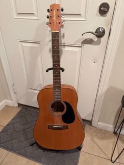 Acoustic guitar and stand