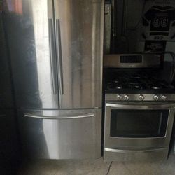 Samsung bottom freezer stainless with a five burner stainless convection oven stove 