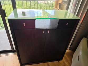 Very nice dark wood cabinet with glass top for sale