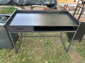Black desk with power outlet