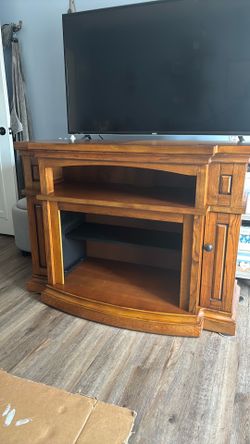 Oak colored TV stand 48 L 19W 36 Tall. Will hold  small electric fireplace insert.