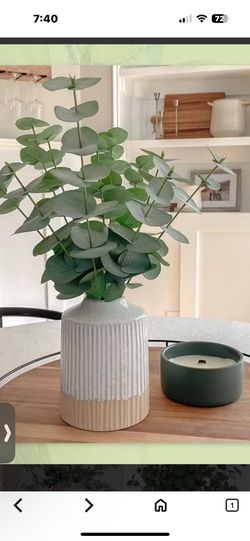Faux decorative plant with vase.