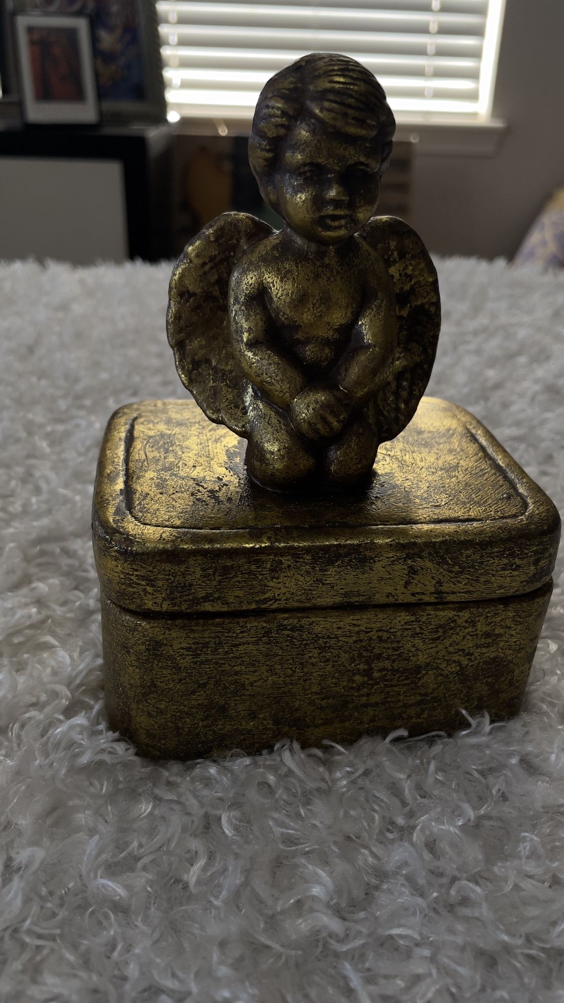 vintage, gold-toned trinket box featuring a angel figure on top from the 1970s.