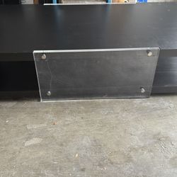Selling a modern low-profile TV stand/media console in good condition. Features a clean dark wood-look finish with tempered glass side panels and chro
