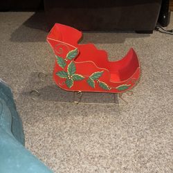 Festive Red Sleigh with Holly Accents. Has a dent in back paint is missing on side see pics 