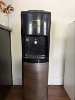Primo water dispenser with four 5 gallon bottles