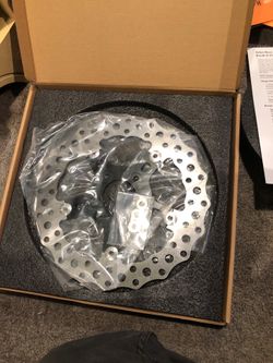 Motorcycle tires, brake pads, and a Rotor
