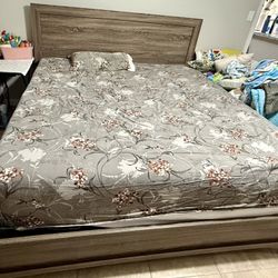 A king-size bed with a mattress, a spring box with a dresser, a mirror, and a chest of drawers.
