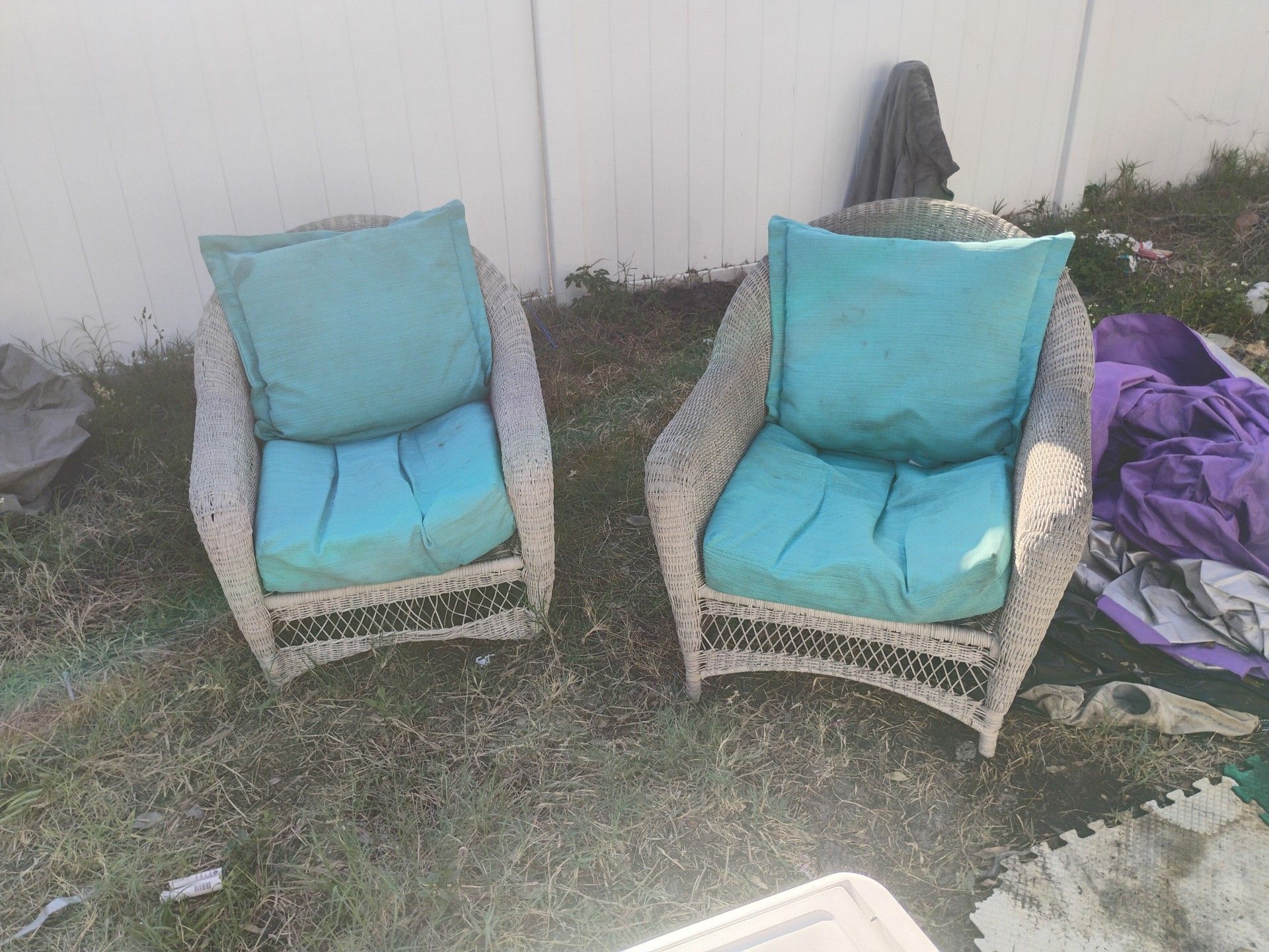 Two wicker chairs with cushions