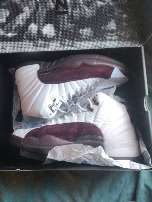 Jordan 12 Retro SP x A Ma Maniére in the white and burgundy crush colorway. 