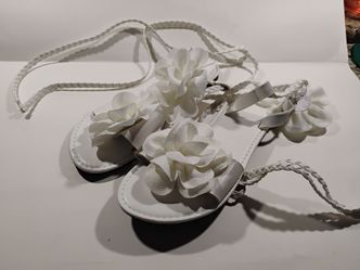 White flat sandals with lace-up back. Size 8