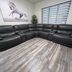 Gray leather reclinable electric couch