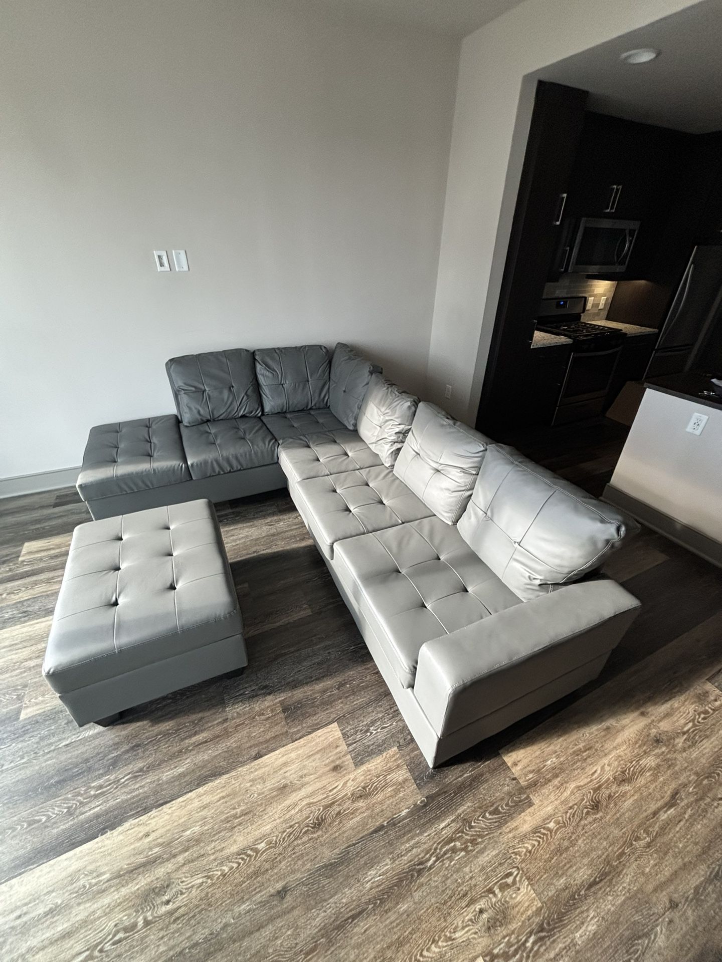 Brand New Leather L-Shaped Sectional With Ottoman And Drop Down Table With Cup Holders