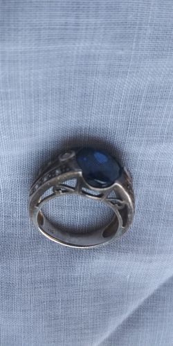 A,SILVER RING SIZE 7 OR 8 UNIQUE DESIGN WITH BLUE GEMSTONE