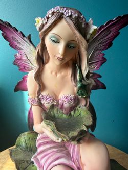Purple Fairy Figurine Sitting by Water