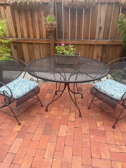 Outdoor wrought iron table with two chairs