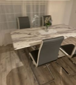 Dining table look like a marble with four chair