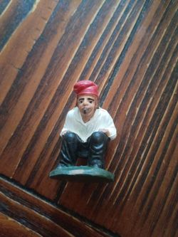 smoking a pipe, and squatting figure