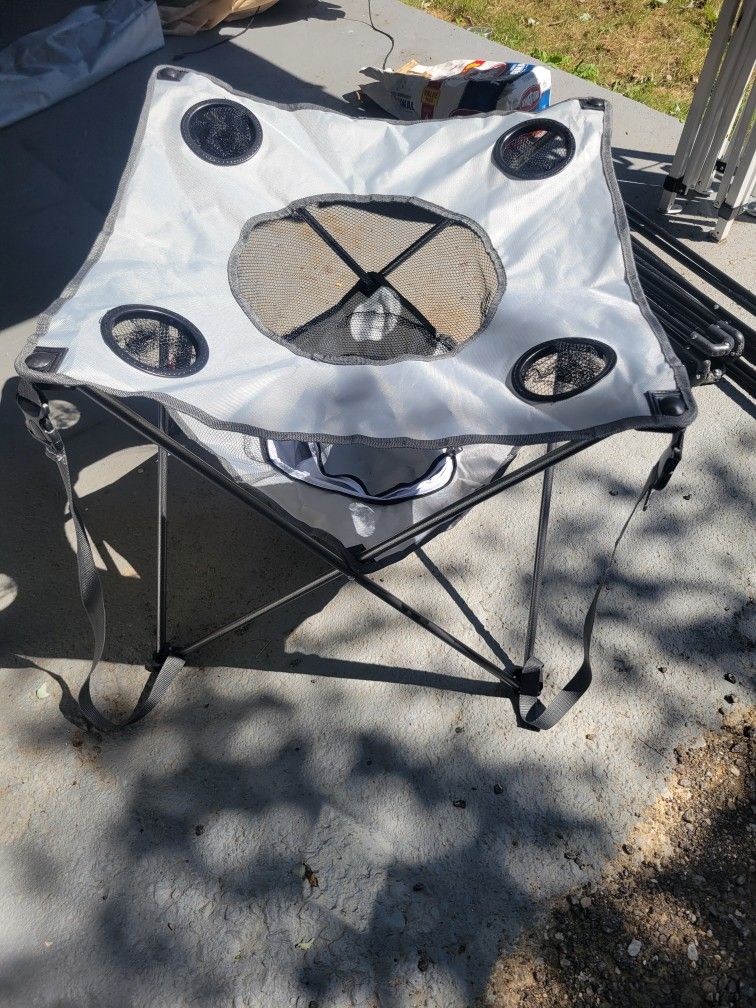 NEW. OUTTERBANKS. CAMPING TABLE WITH COOLER AND SNACKHOLDER. WITH CARRYING BAG
2  COLORS.  GREY. GREEN. 
 11525 S HALSTED.  Dunkin Donuts/
7111.S WEST