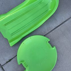 Green plastic Snow Sleds 